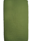 A textured green blanket neatly folded into a rectangle, with a uniform color and subtle fabric detailing, placed against a plain, light background in a DockATot Kind Essential Bassinet - Willow Boughs.