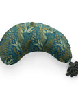 A vibrant teal La Maman Wedge - Navy Night Falls nursing pillow decorated with a golden tropical leaf pattern, featuring a tasseled embellishment on one end. The pillow is shaped to provide neck and breastfeeding support and is isolated on a white background.