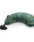 An eye mask with a tropical leaf pattern in shades of green, blue, and yellow, shaped to fit over the eyes and bridge of the nose, featuring a black elastic strap and lumbar support - LAST CHANCE: DockATot La Maman Wedge - Navy Night Falls.